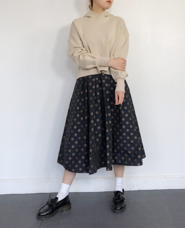 ネイビーの神戸・山の手ゴールドドットスカート ベージュのパーカー ブラックのローファー